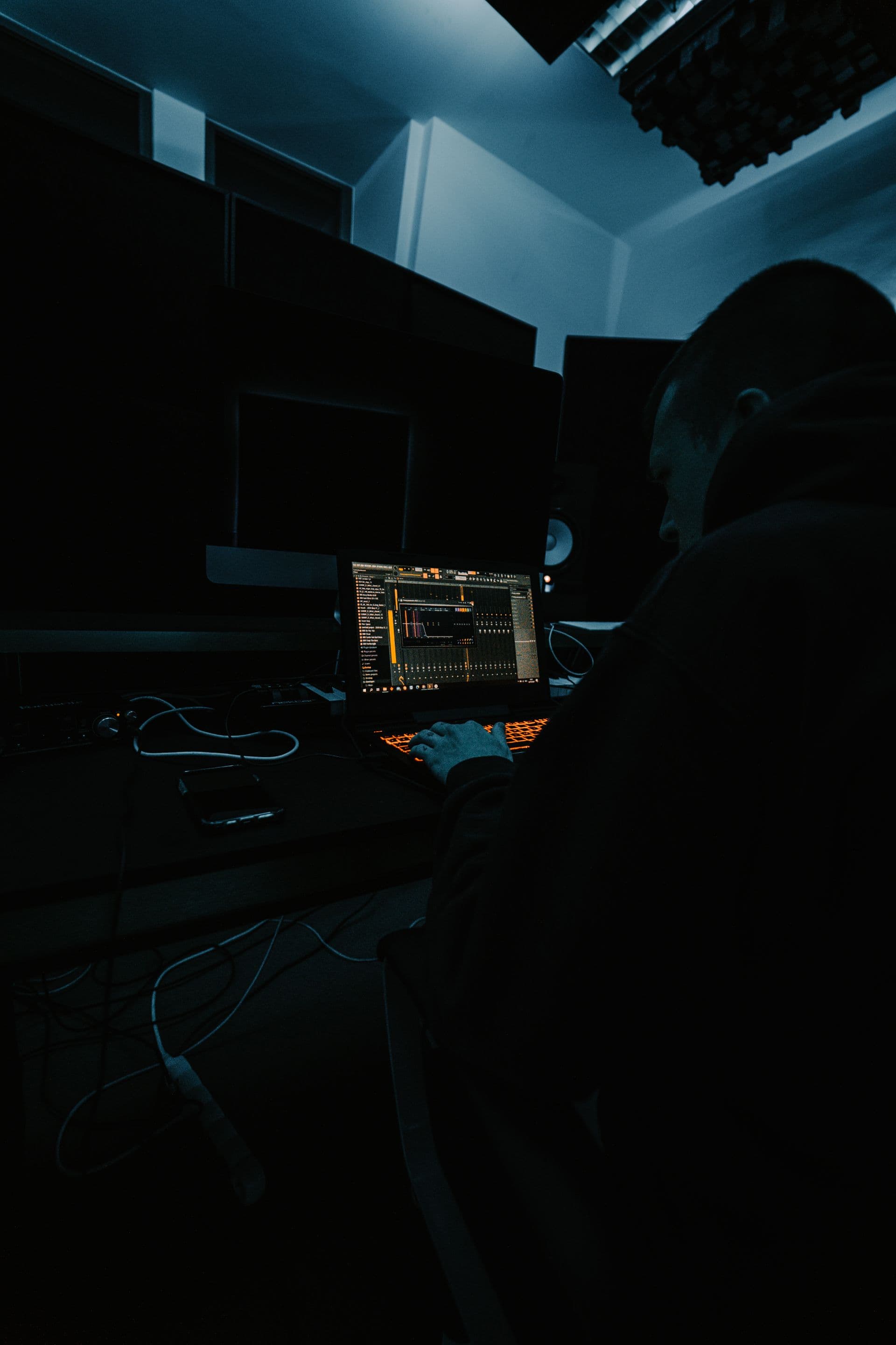 Studio producer in dark moody setting